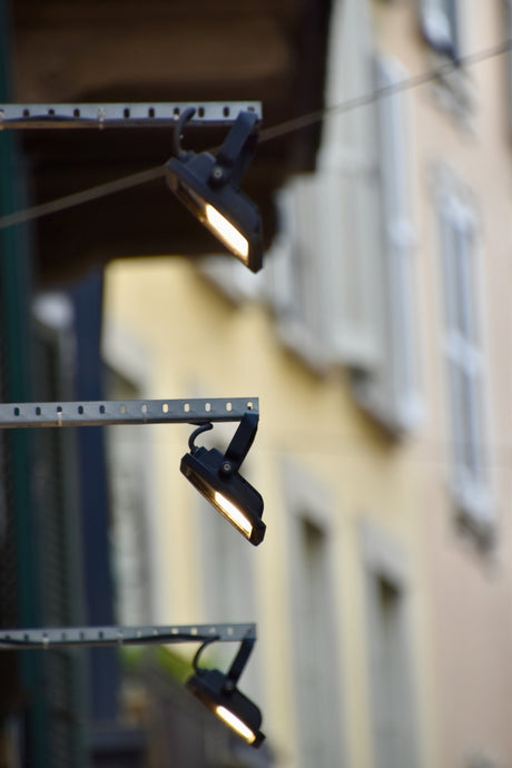 a couple of street lights hanging from the side of a building