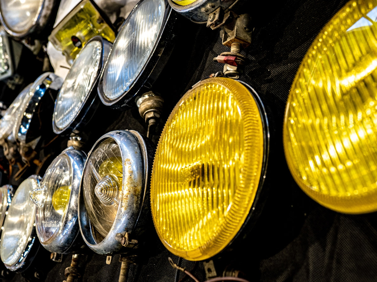 Various vintage car headlights on display.