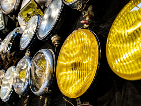 Various vintage car headlights on display.